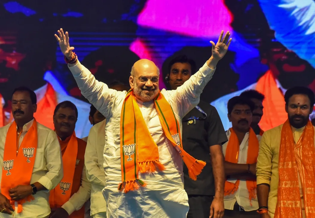 Amit Shah greets attendees at a public meeting in Hyderabad.
