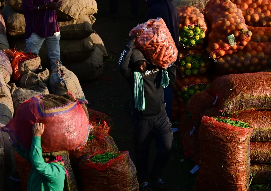 Vendors unload vegetables at Bowenpally market yard in Hyderabad.